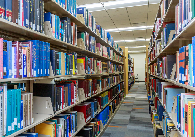 Books on shelves in a long library row