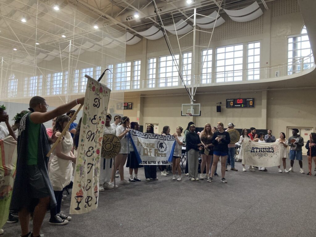 Many students standing with their patron deity banners.