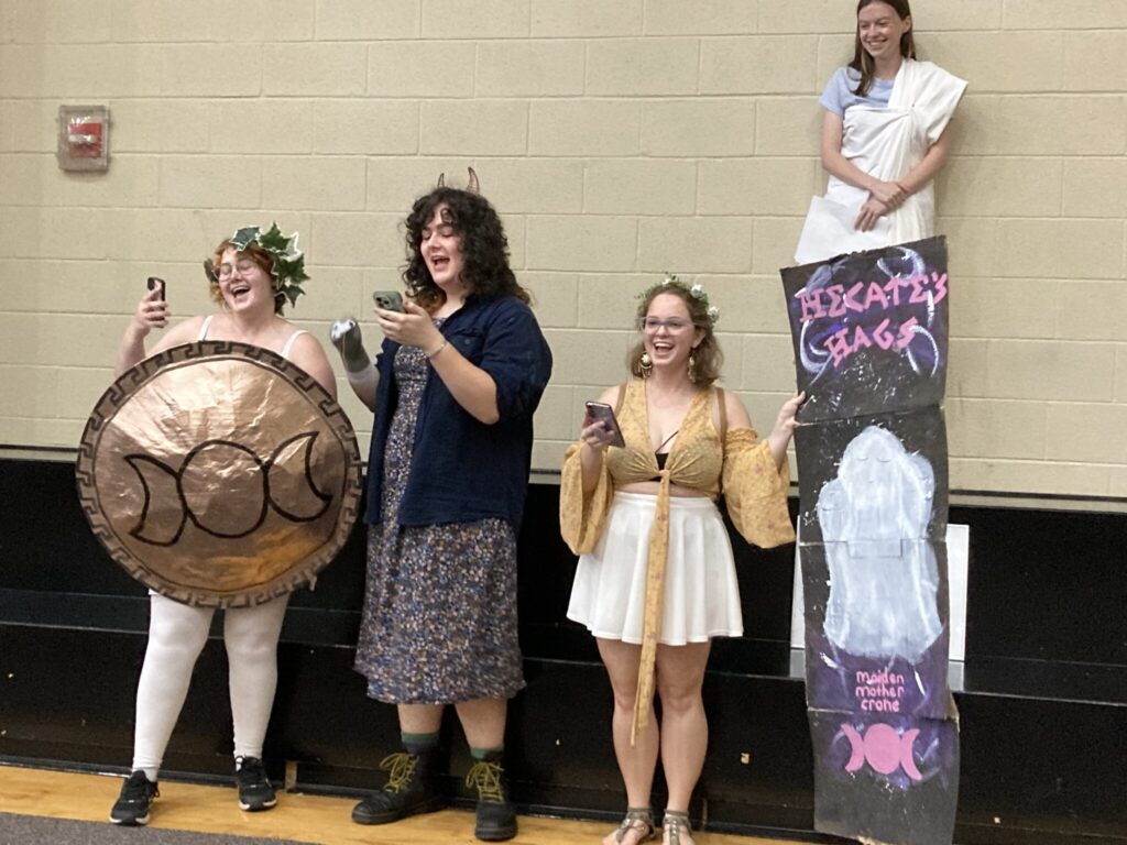 Four students stand to perform.